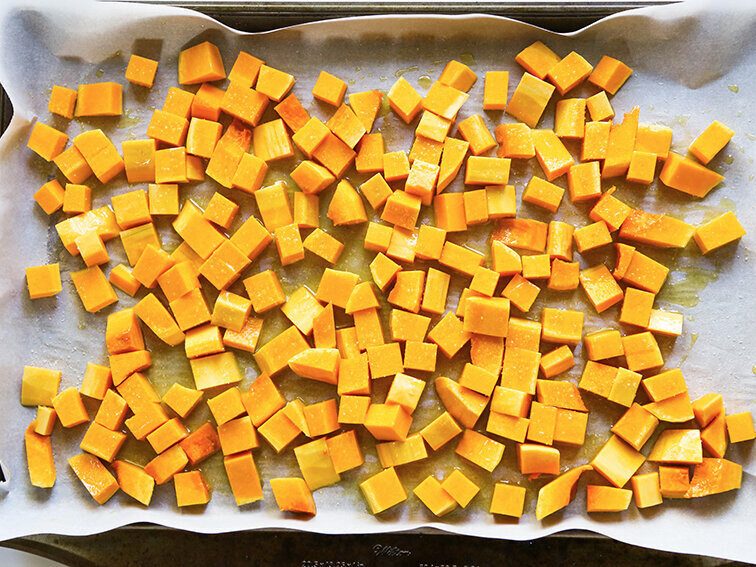  Cubed squash on baking sheet with olive oil 