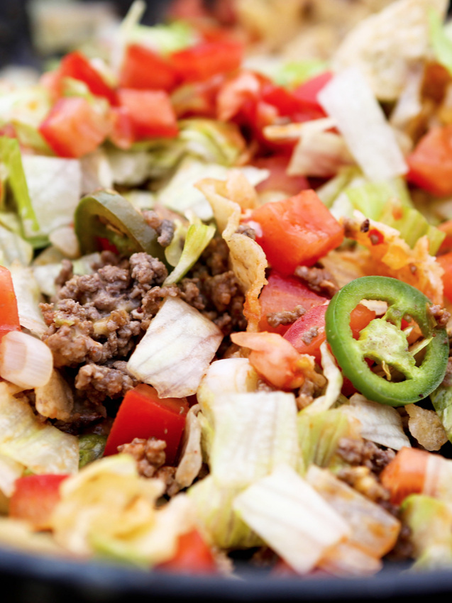 Close up of campfire nachos focusing on jalapeno slice