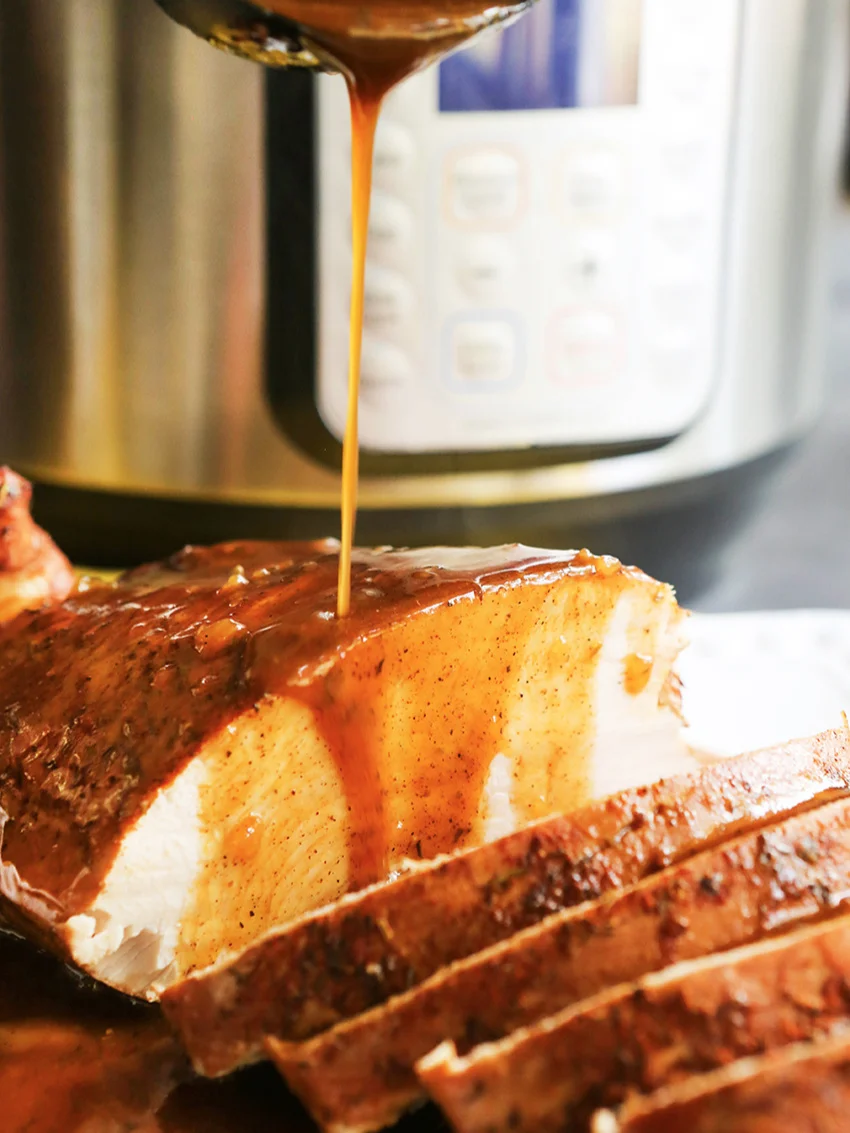  Gravy being drizzled over sliced turkey breast 