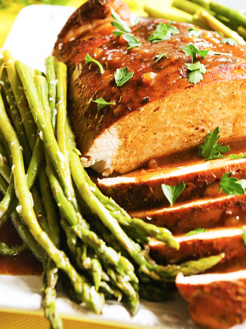 Instant Pot Asparagus on a serving platter with turkey and gravy 