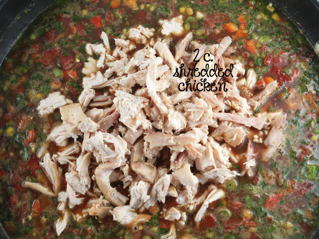  Soup in crockpot with heaping pile of chicken ready to be stirred in 