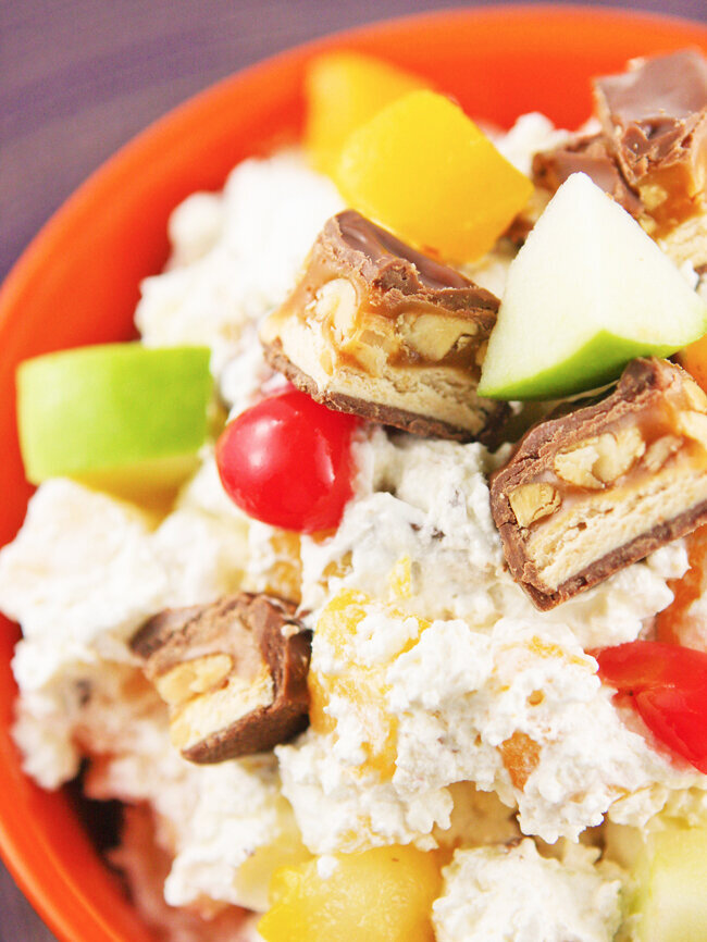  Close up of snickers fruit salad in an orange bowl 