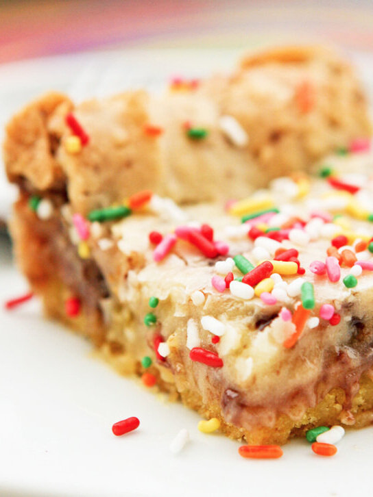 close up of a slice of paula deen gooey butter cake with colored sprinkles 