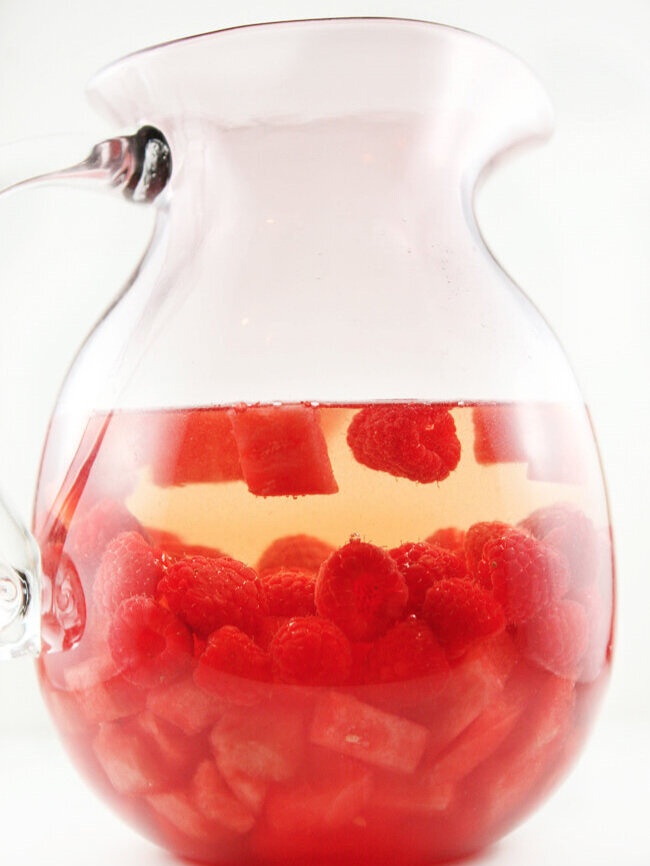  Side view of pitcher of watermelon raspberry sangria 