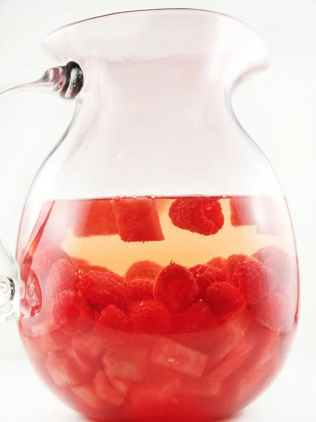  Side view of pitcher of watermelon raspberry sangria 