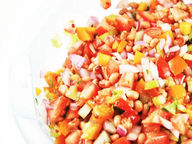  Mixed black eye pea salad in mixing bowl 