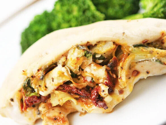  Close up of cooked chicken breast stuffed with artichokes and tomatoes 