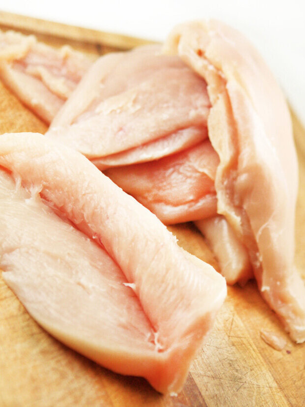  Chicken breasts with slits cut into them ready for stuffing 