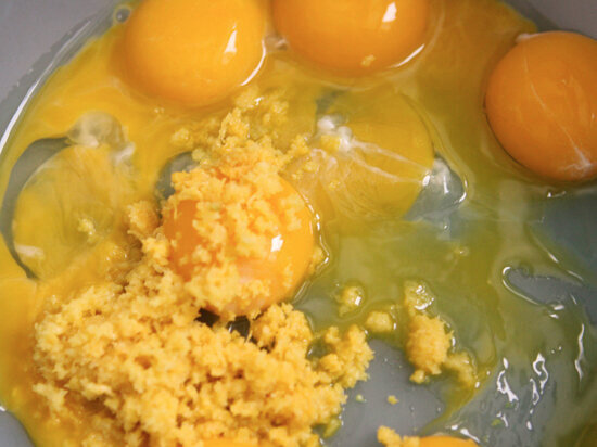  eggs and lemon zest in a bowl 