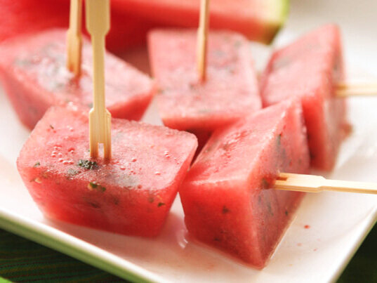  Watermelon ice cube popsicles with toothpicks stuck in them 