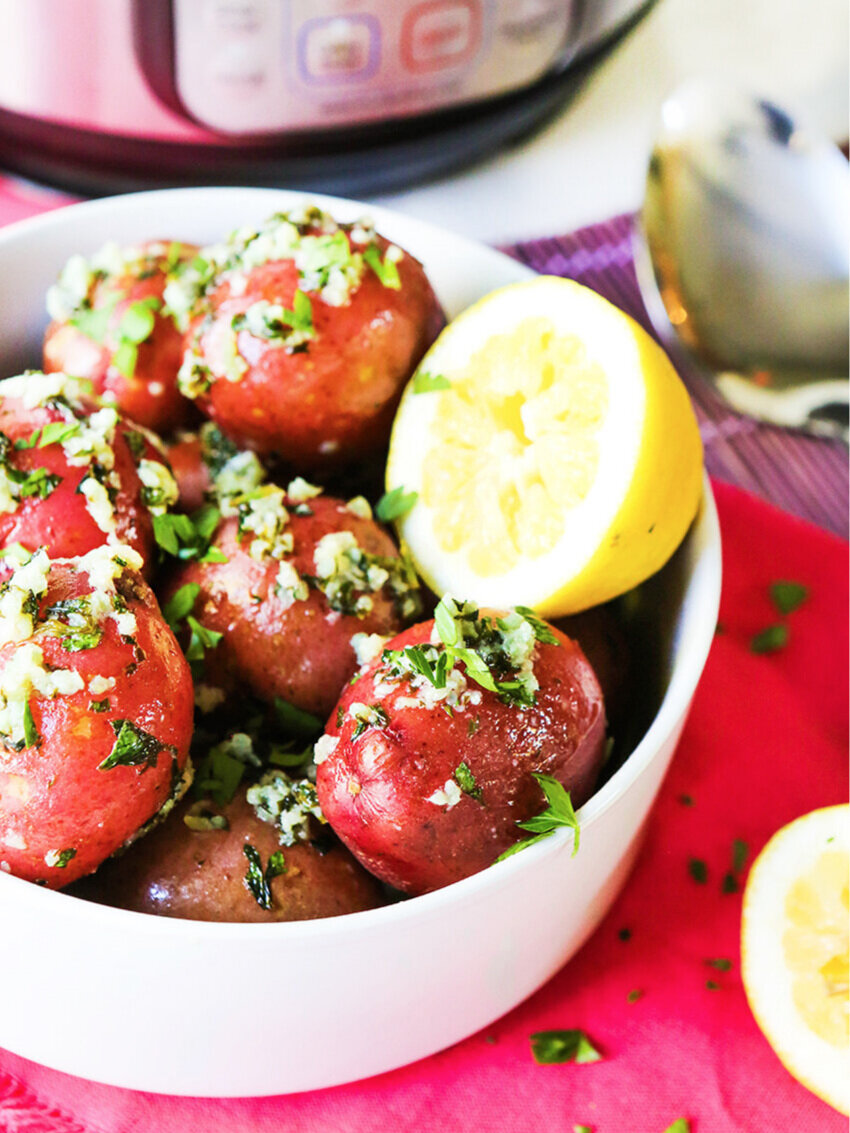  Serving bowl of red potatoes with half a lemon in it sitting next to Instant Pot 