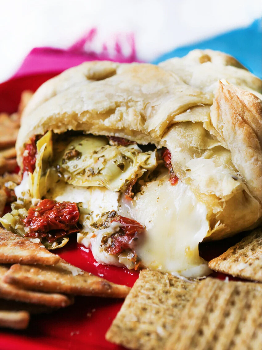 Pesto Baked Brie with Artichokes and SunDried Tomatoes