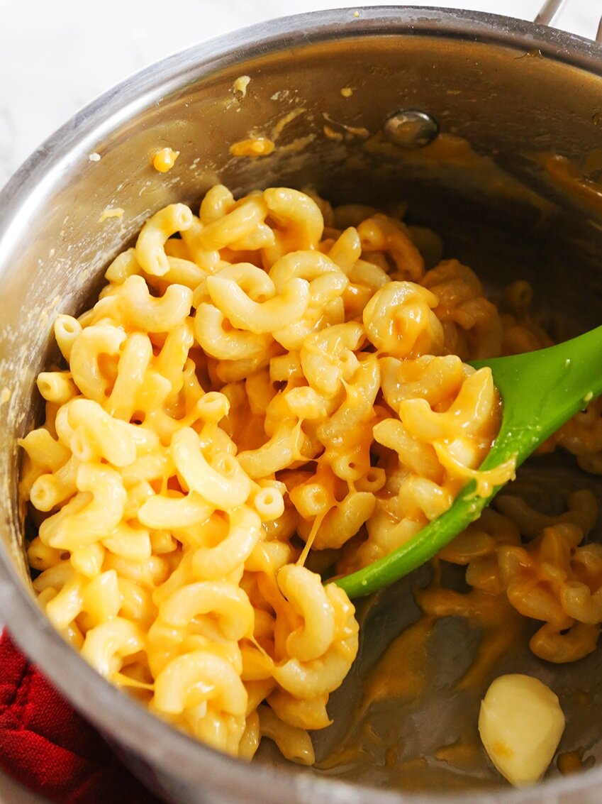 saucepan filled with cheesy mac and cheese 