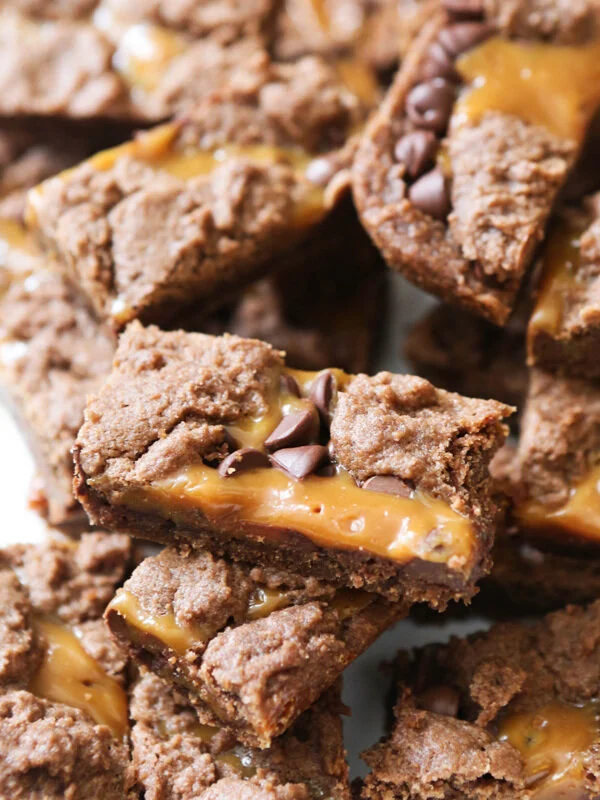 Huge pile of chocolate caramel brownies cut into rectangles 
