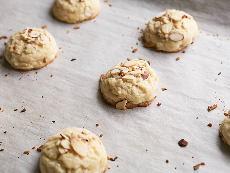  almond cookies on parchment just out of the oven 