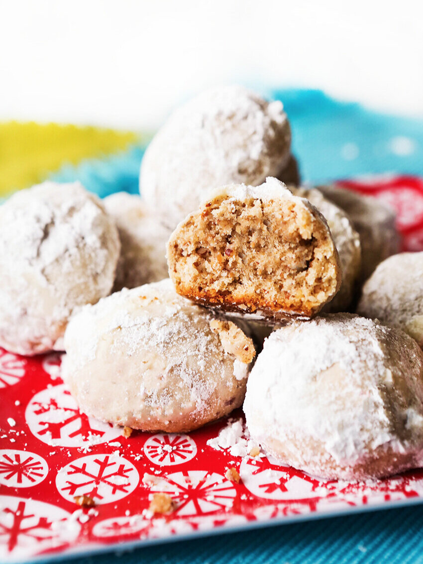 Stack of pecan balls on a festive plate