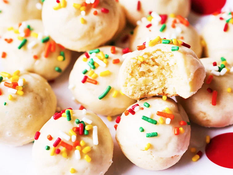 stack of italian christmas cookies with a bite taken out of top one 