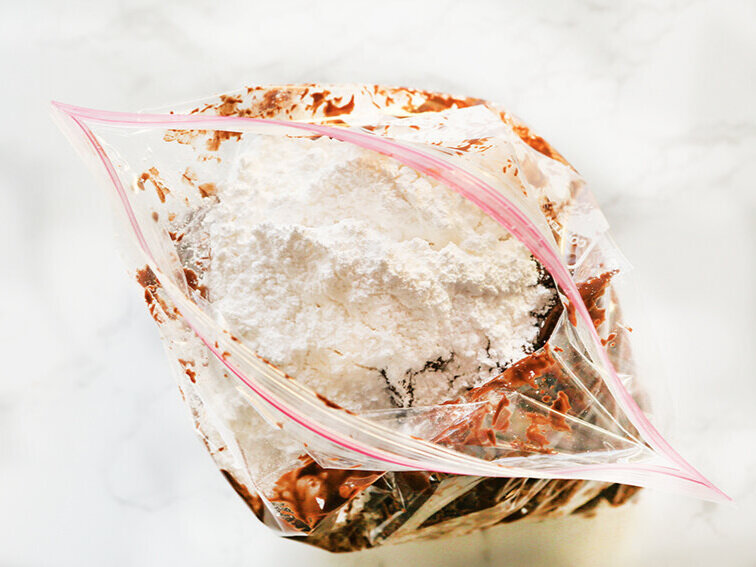 puppy chow in ziploc bag with powdered sugar 