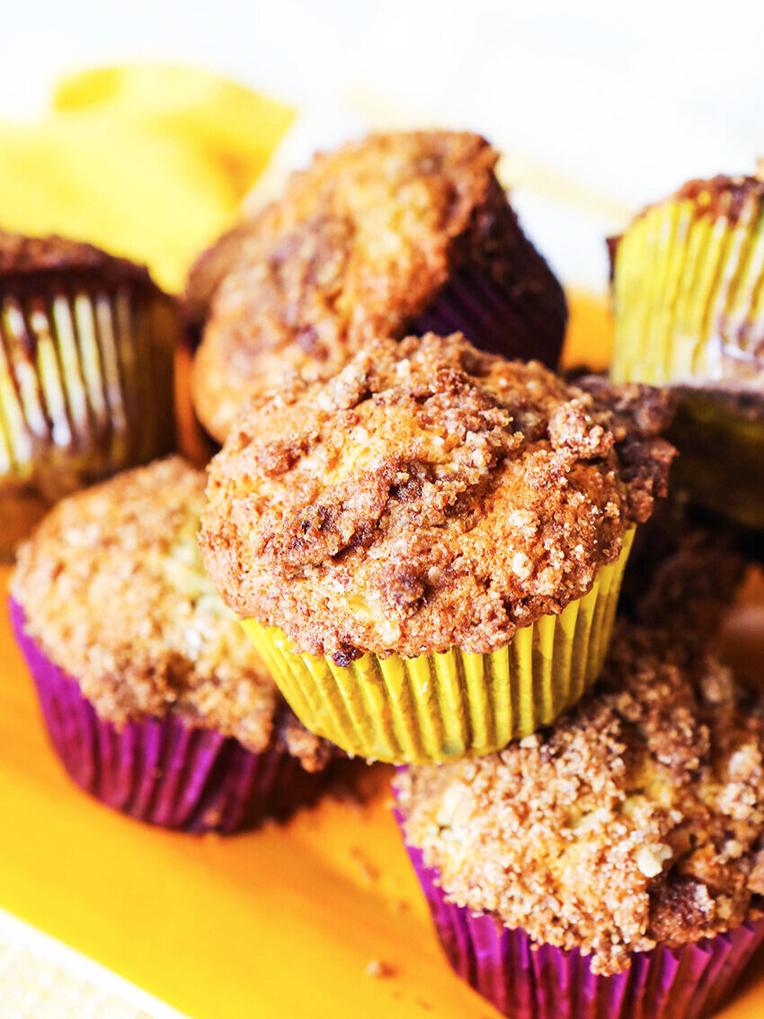 banana crumb muffins stacked on a plate, ready to eat 