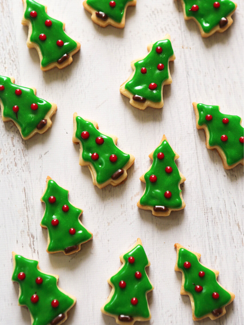 Tiny Christmas tree shaped cookies with green icing 