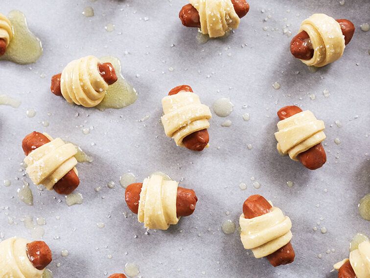 pigs in a blanket on baking sheet ready for baking