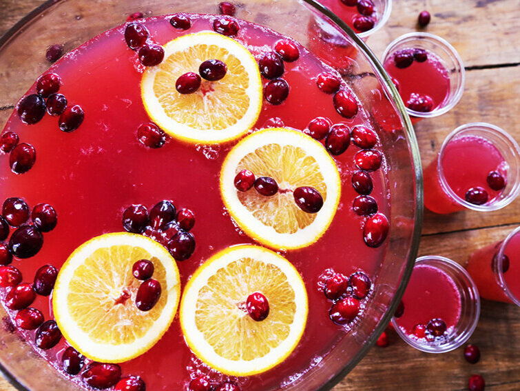orange slices and cranberries in holiday punch bowl 