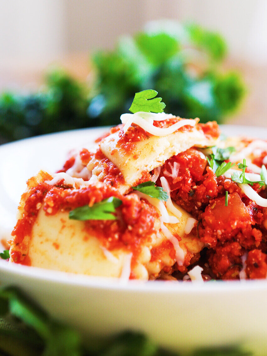 Heaping bowl of cheese ravioli with parsley