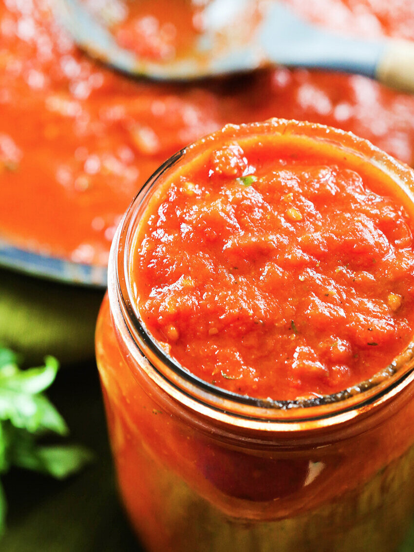 close up of mason jar filled with marinara sauce