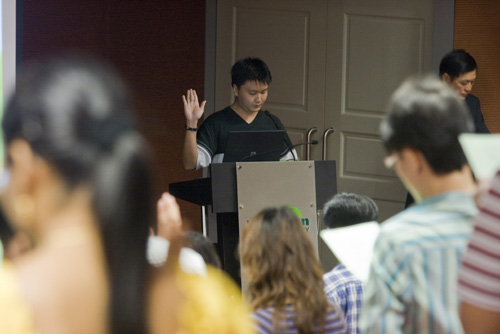 WOU web designer and new WOU student Johnathan Tan leads in the oath-taking,