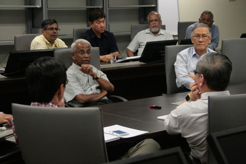 Prof Dhanarajan (facing, 2nd from left) gestures as he offers his input.