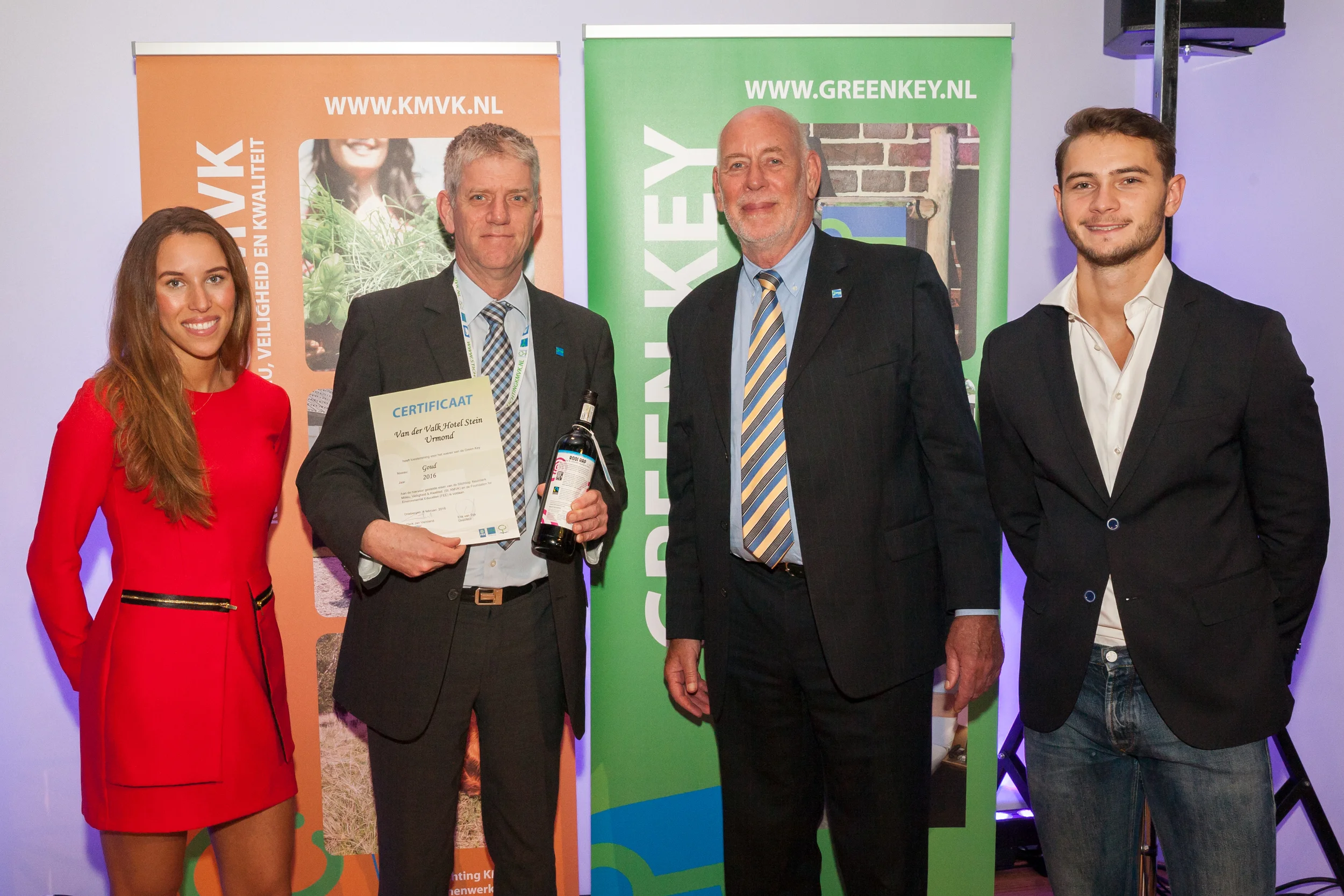 Green Key site owner receives certificate from Green Key Chairman Derk Jan Verstand surrounded by models from WearEver. 