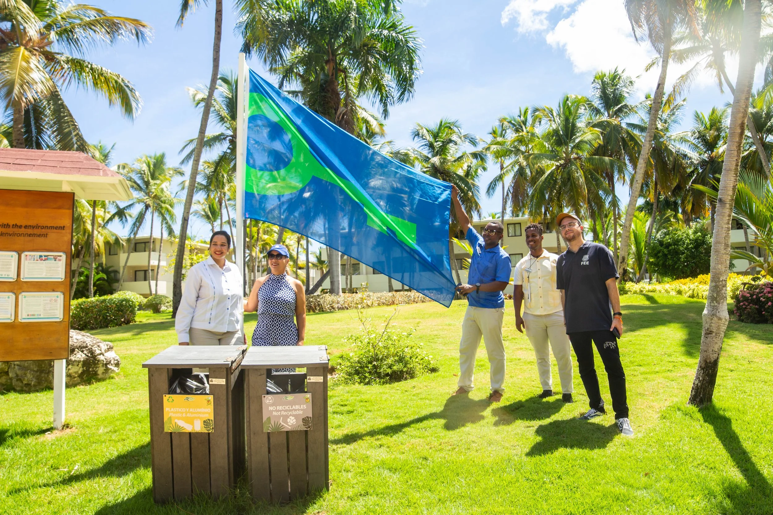 The Green Key flag and happy people in an establishment in the Dominican Republic
