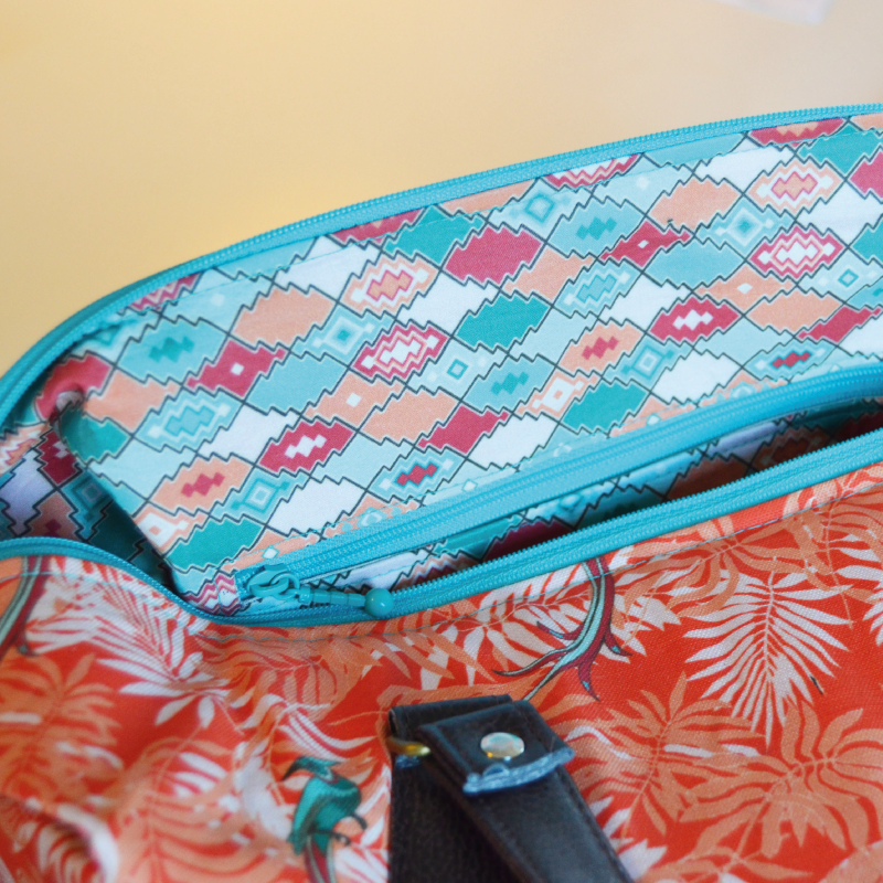 The interior fabric with pattern design "Sahara Rokoko" is cotton. The roomy interior has a zippered side pocket.