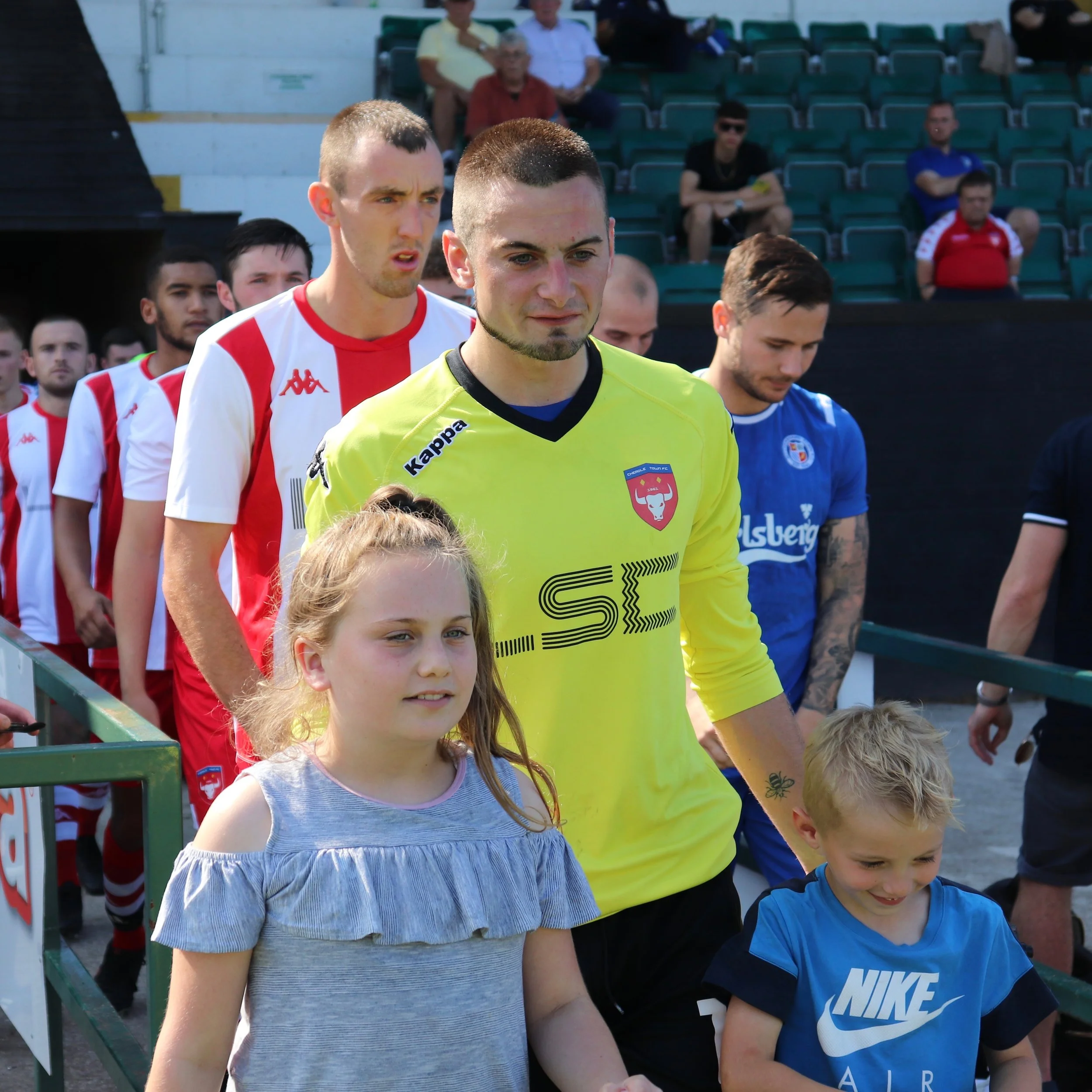 Danny Whiting and our two mascots for the day lead the teams out