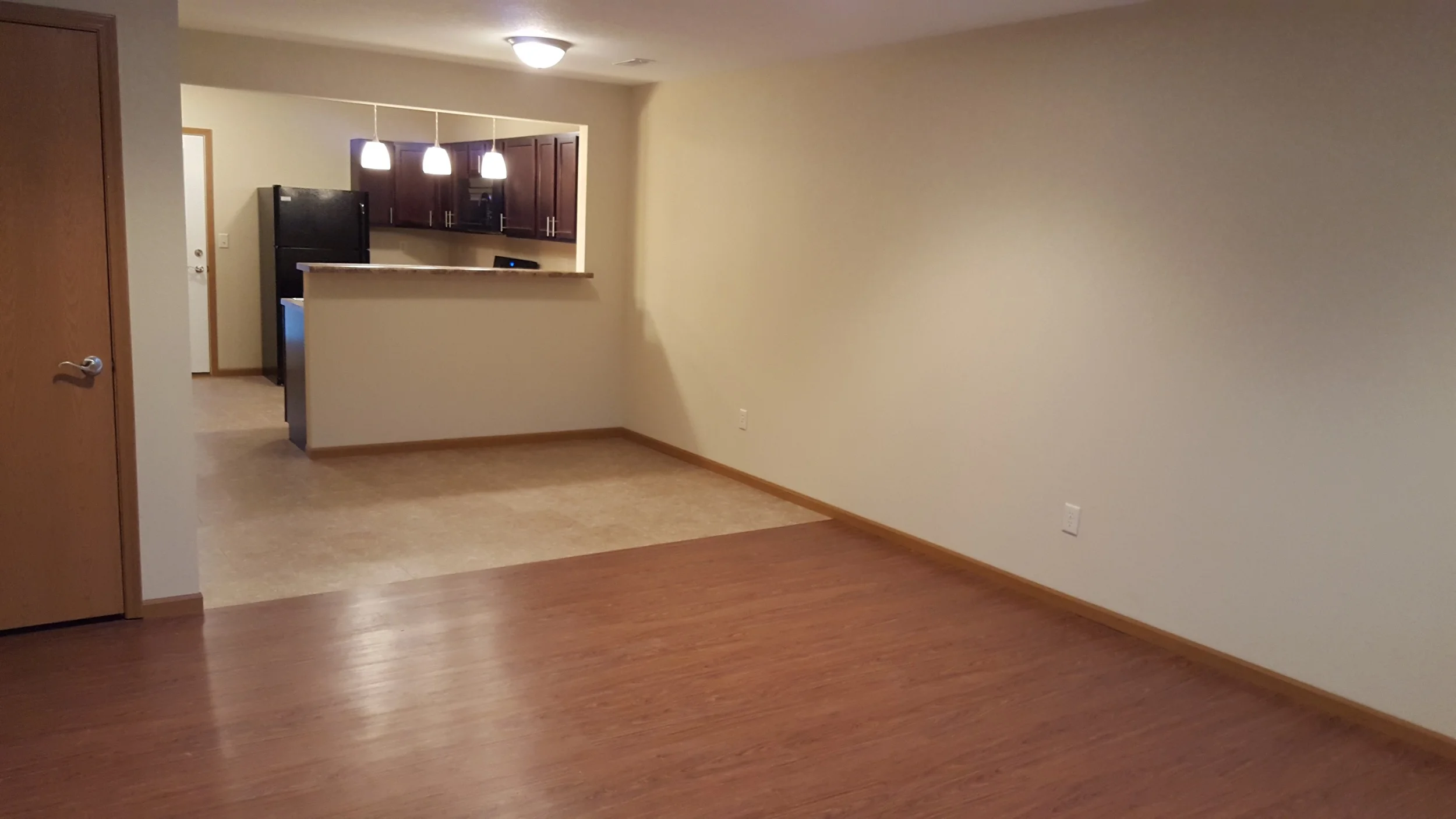 2 bedroom looking into kitchen from living room