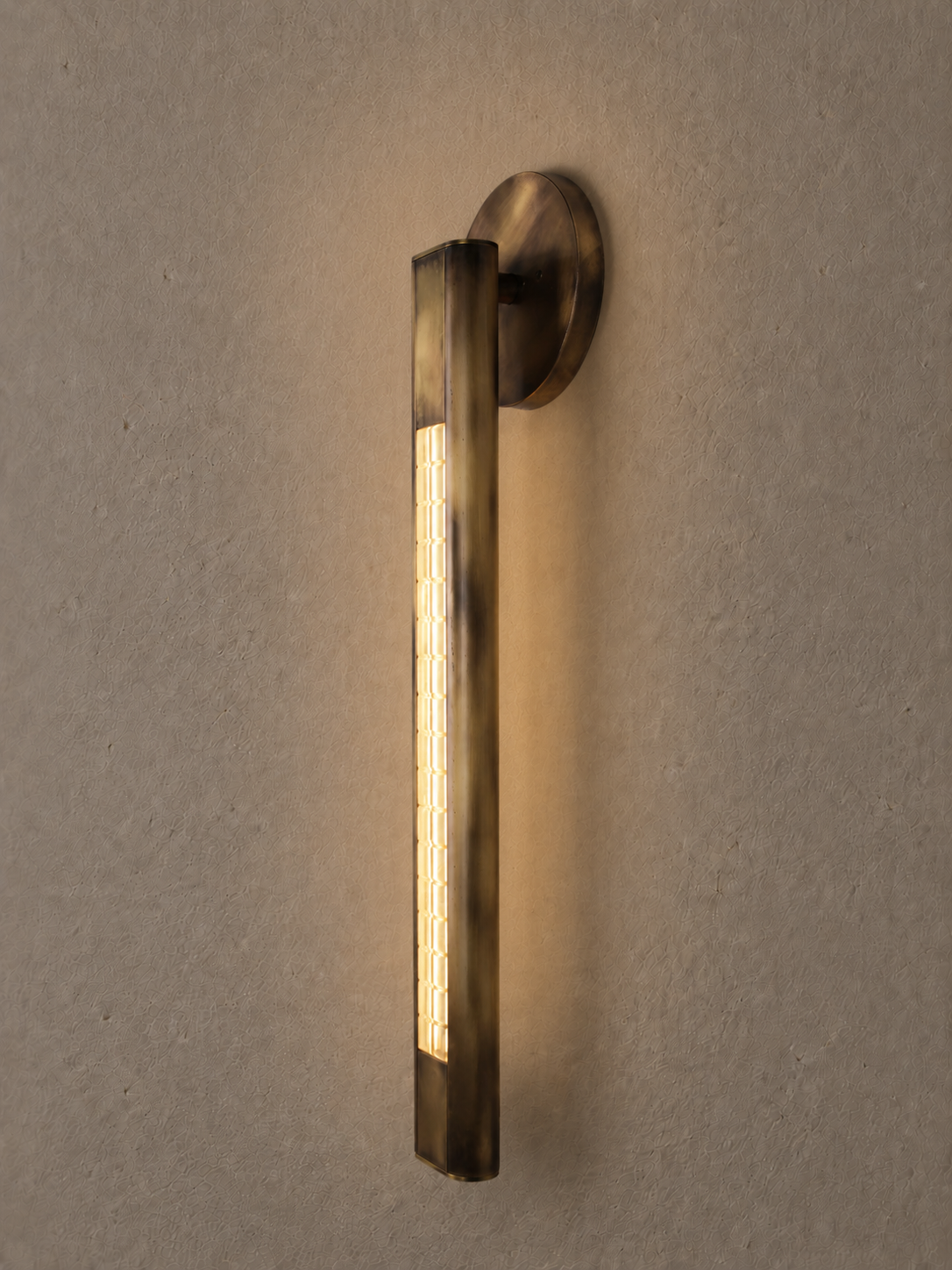 Daikon Studio Yakat Wall Sconce Aged Brass Angle Gray Wall.png