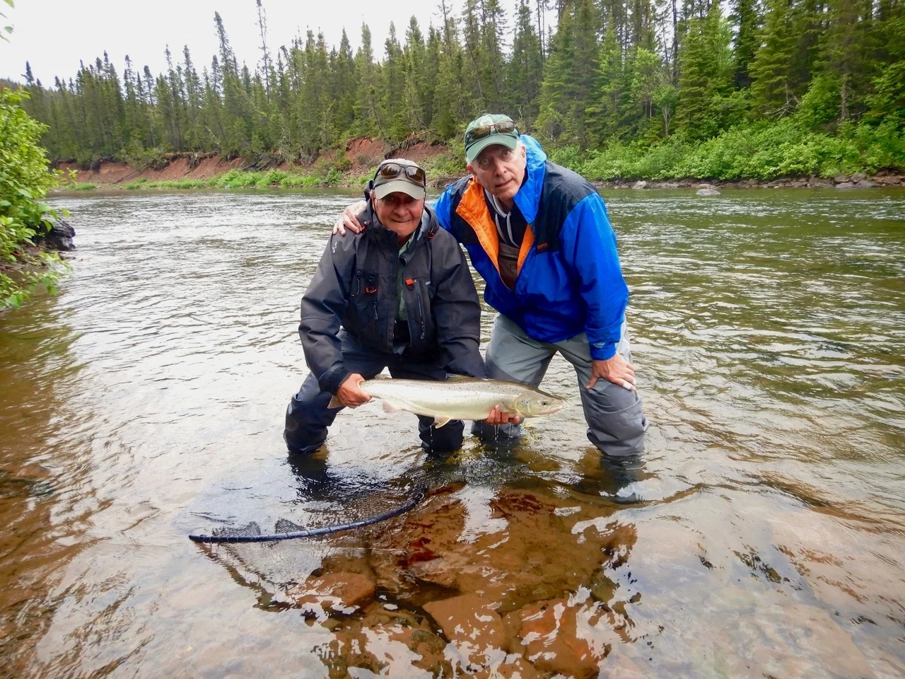 Bill McAlpin (right) and Salmon Lodge master guide Clement Bernier with Bill’s first one from the Grand! Cascapedia