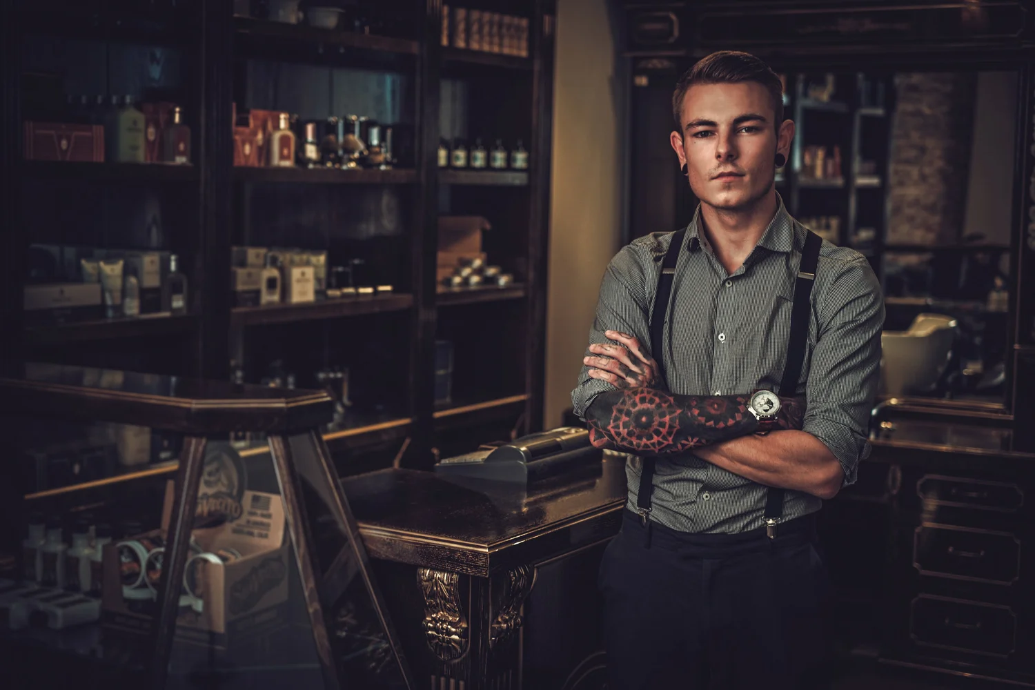 Barber with crossed arms standing in a classic barber shop