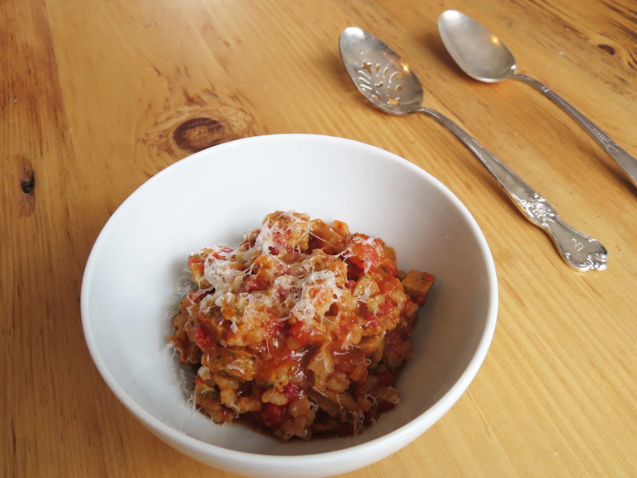  ½ c brown rice, cooked 1 Chicken Sausage, small dice (I used Al Fresco Chicken Sausage- Sweet Italian) ½ c chopped tomatoes (fresh or canned) 1 tsp Italian seasonings ¼ c water 1 bay leave S/P 1.) Heat medium saute pan over medium - heat, when hot add a touch of cooking oil and add diced Chicken Sausage. ( I use EVOO or Coconut Oil that comes from a spray bottle) 2.) Once the sausage gets slightly browned add, rice tomatoes, water, seasoning, bay leaf and bring to a boil, and then let simmer and stir occasionally. 3.) Let mixture simmer softly until most of the liquid has evaporated. Season with salt and pepper to taste. 4.) Top with a little grated parmesan and/or fresh herbs. Serve hot! I always try to have cooked brown rice in my fridge along with some things that are easy to heat up quickly. Pre chopping ingredients is always a good idea if you know you will use them within a couple days. I also suggest grating your cheeses on a microplane or citrus zester. This will allow for the cheese be sliced thinner giving it a much lighter fluffier texture, and be more easily distributed over the dish. This technique is also good for when you are grating cheese over salads. Variations: Throw an over easy egg on top and make breakfast! Add chopped broccoli or leafy greens for some more fiber and nutrients.