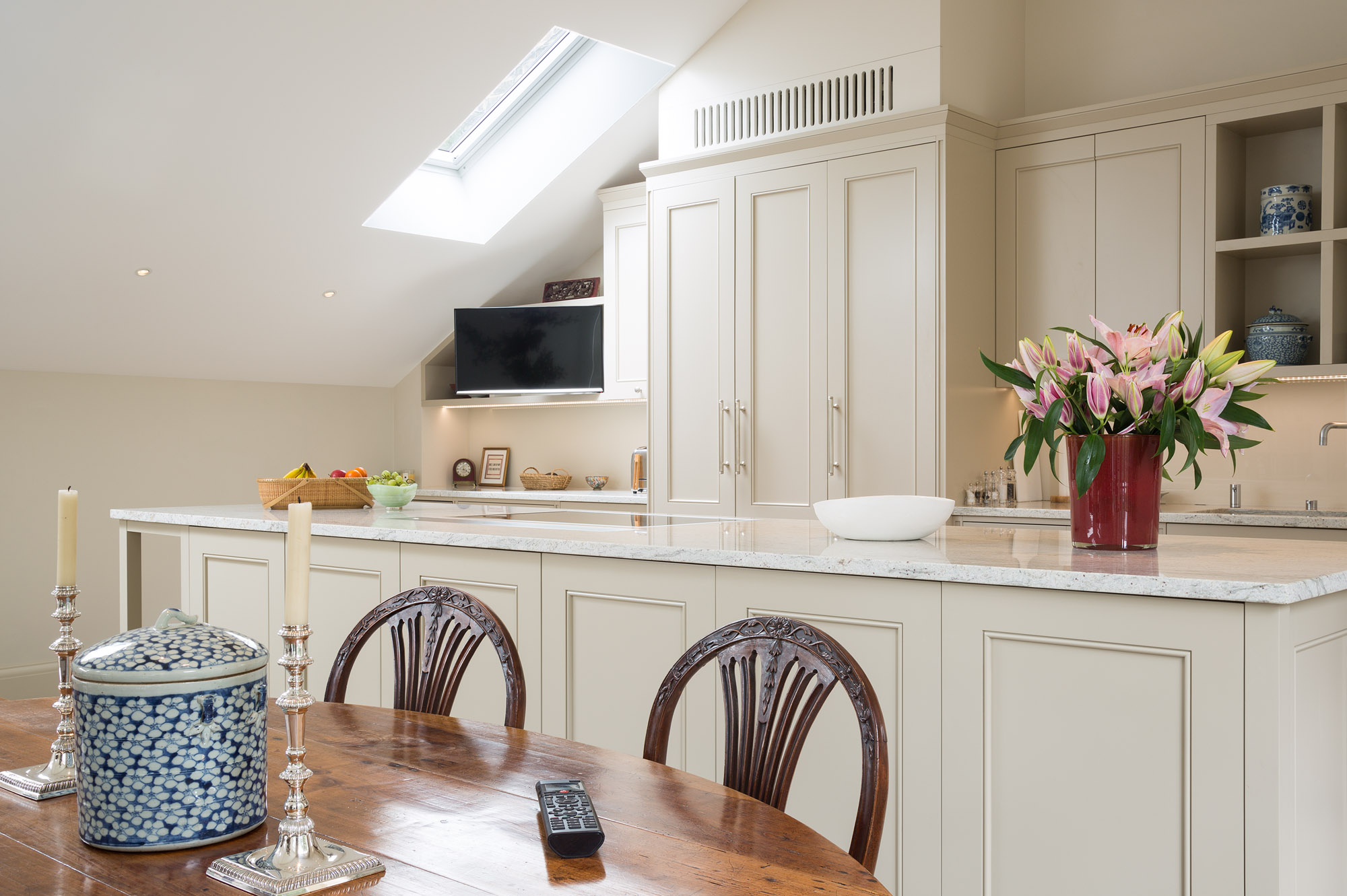 The Kitchen and Dining areas can view the TV which is mounted on a pull-out and swivel bracket. The TV and In-ceiling Speakers can be controlled from the Control4 handheld remote, or iPad/iPhone app.
