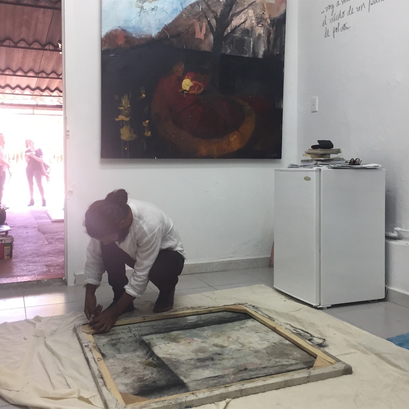In the home and studio of Eddy Maikel Sotomayor, the artist removing stretcher-bars in order to roll the canvas for transport