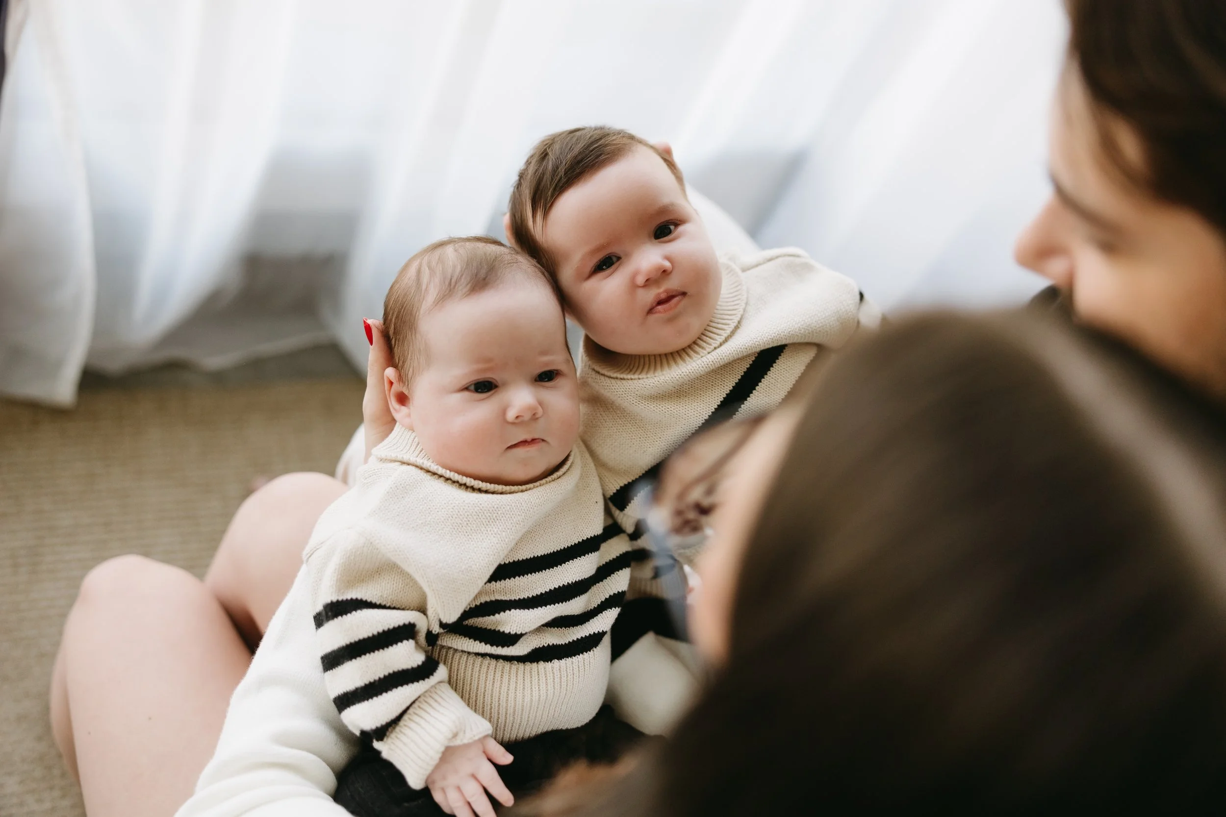 deux bébés qui regardent leurs parents dans une séance photo dans la ville de Québec