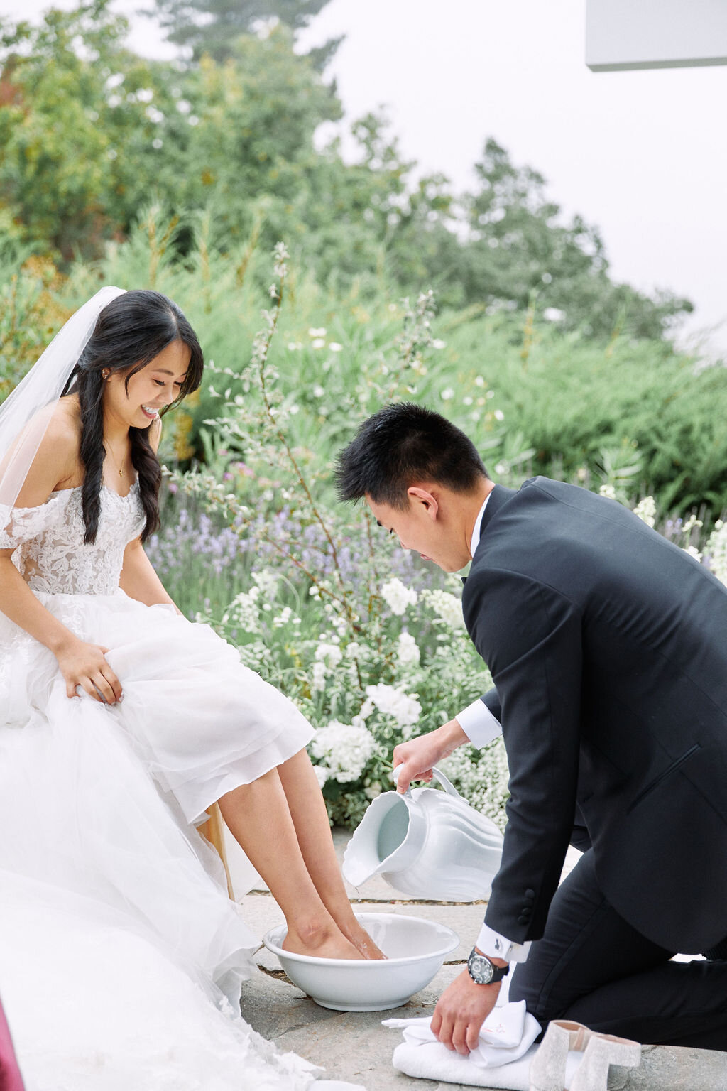 groom washes brides feet wedding ceremony
