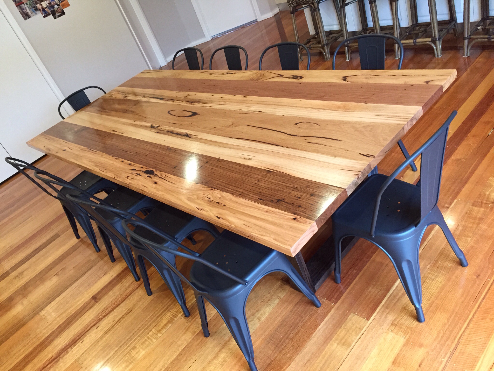 Recycled mixed hardwoods dining table with black stained legs