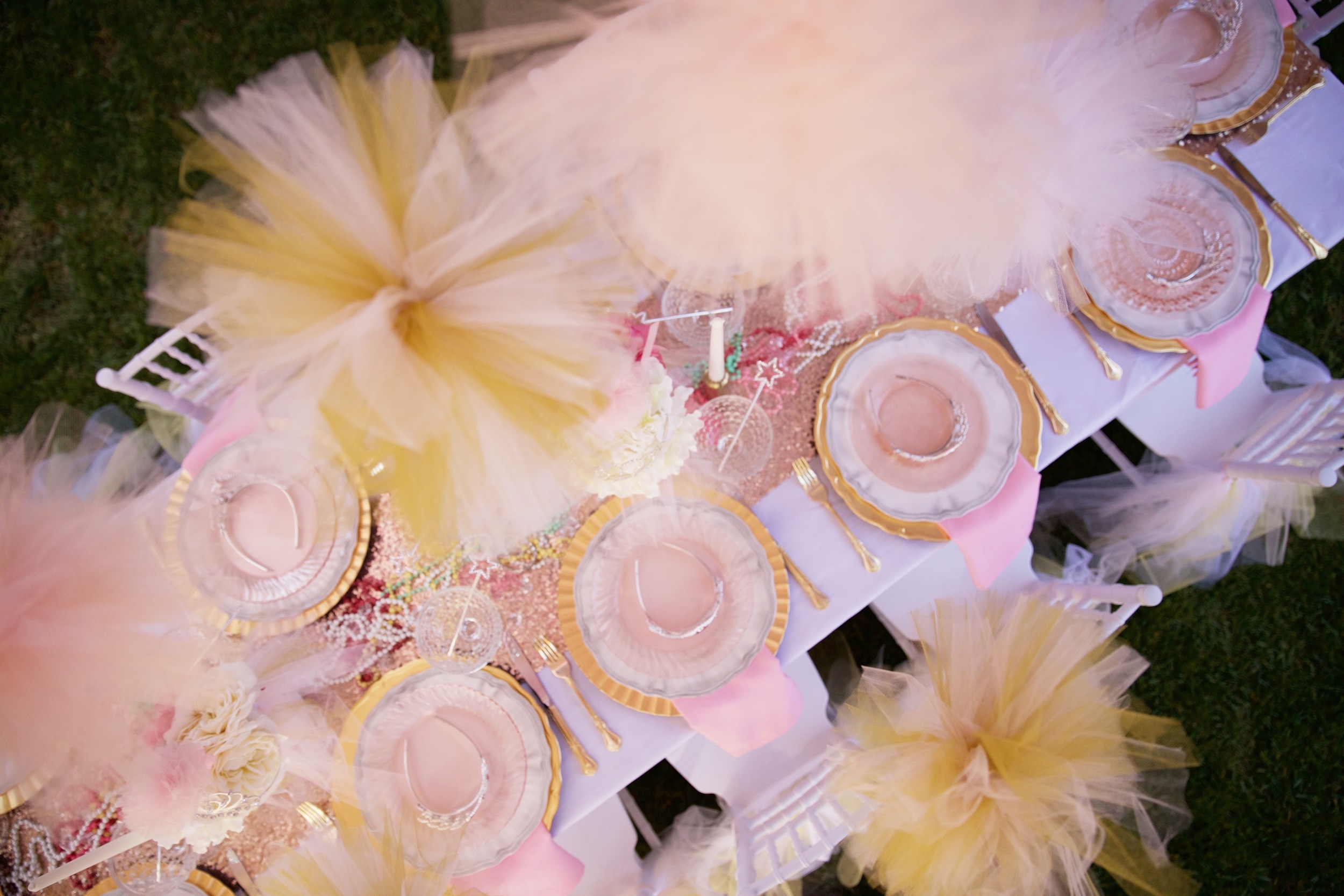 Copy of A rental collection with an elaborate ensemble of pink tutu centerpieces, white chiavari chairs, glittery runners, pink and white flowers, and sparkling tiaras that will dazzle even a Queen! 