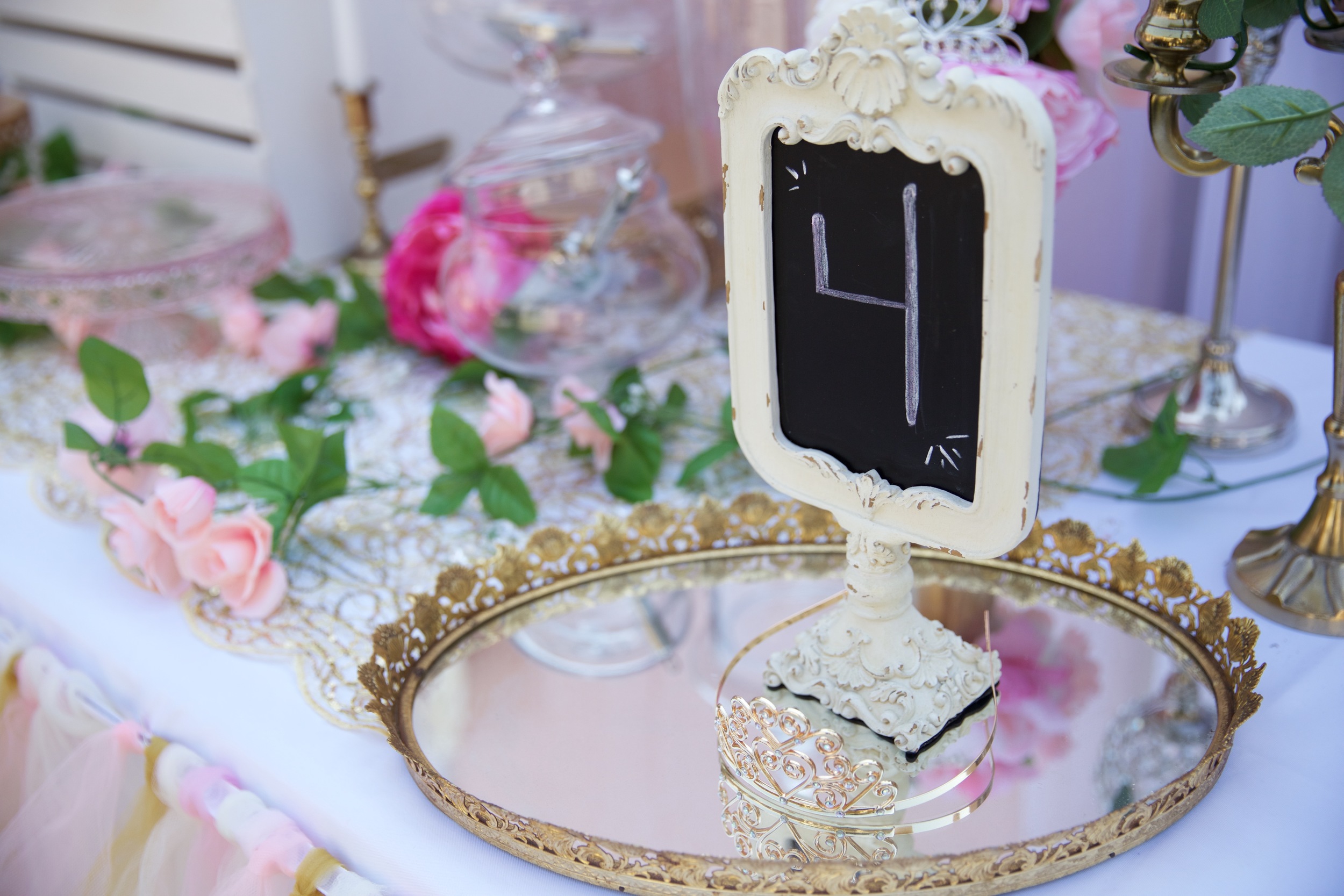 Copy of A rental collection with an elaborate ensemble of pink tutu centerpieces, white chiavari chairs, glittery runners, pink and white flowers, and sparkling tiaras that will dazzle even a Queen! 