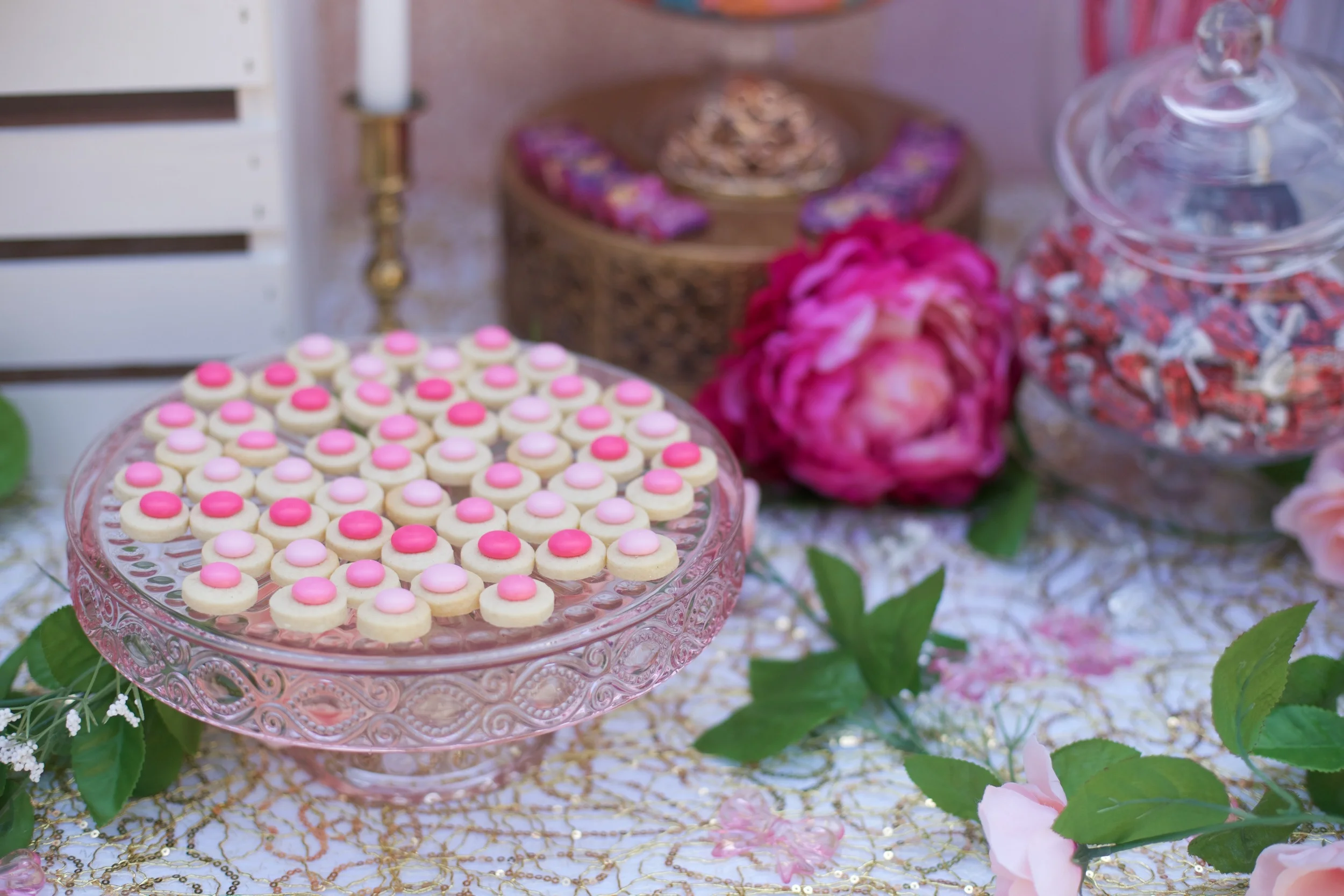 A rental collection with an elaborate ensemble of pink tutu centerpieces, white chiavari chairs, glittery runners, pink and white flowers, and sparkling tiaras that will dazzle even a Queen!