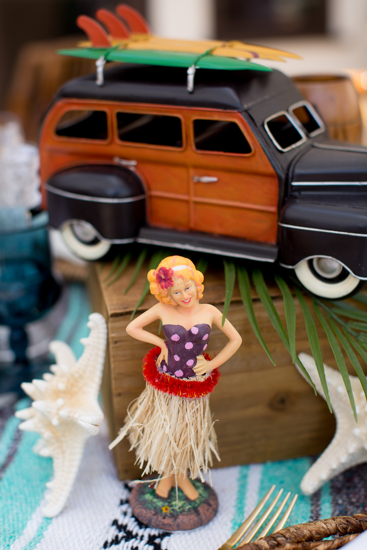 A vintage surfer inspired rental collection! Hang loose with our vintage mini VW buses, pin up dashboard girls, touches of Tiki, palm leaves and tropical faux florals.