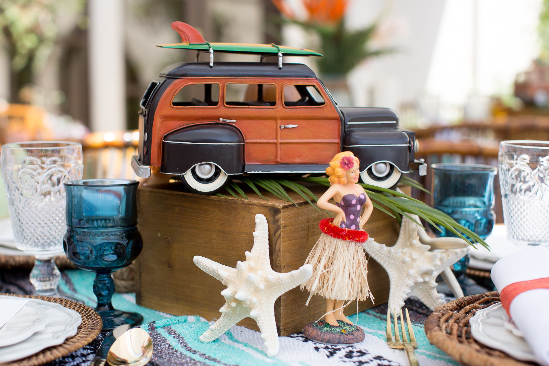 A vintage surfer inspired rental collection! Hang loose with our vintage mini VW buses, pin up dashboard girls, touches of Tiki, palm leaves and tropical faux florals.