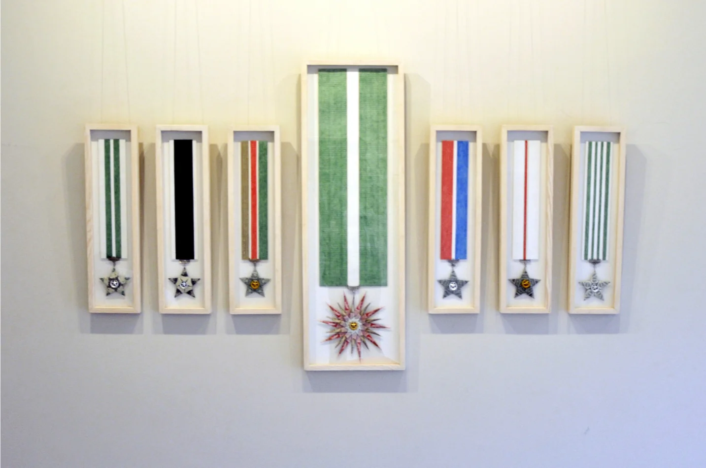 Decorations , 2012, Installation view, Charcoal, chalk pastel, coloured pencil and typed on Canson paper, metal and folded one US$ and Pakistani Rs. banknotes, Dimensions variable